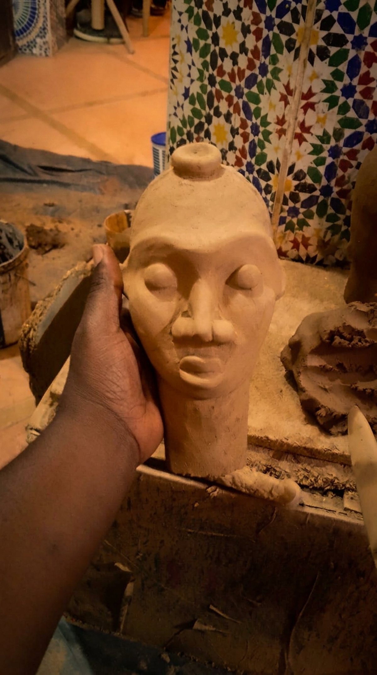 The head at raw clay stage in the workshop